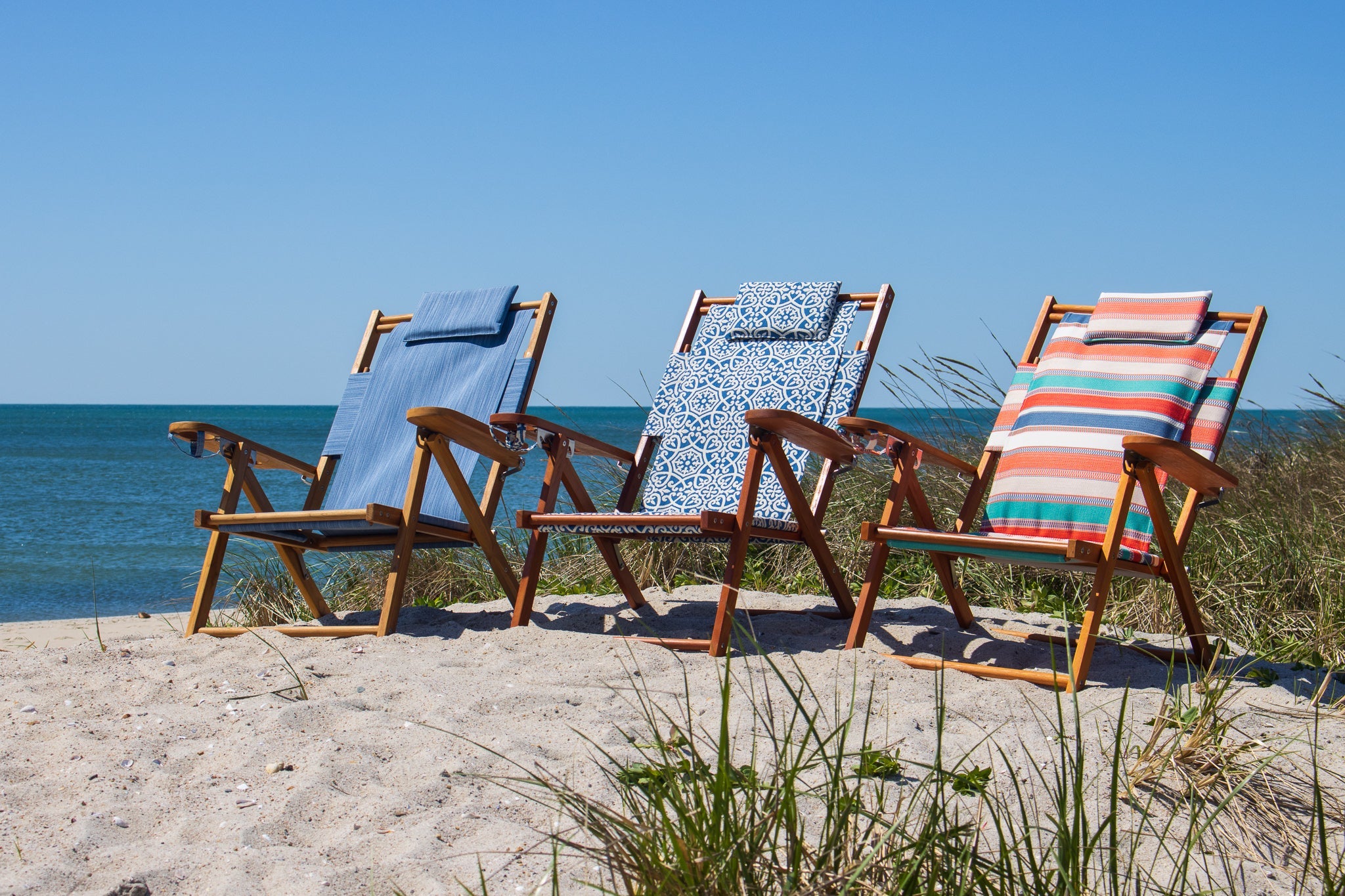 3 colorful beach chairs on the beach Cape Cod MA