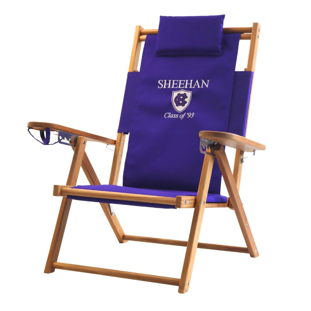 A purple beach chair embroidered with the Holy Cross logo, student name and graduation date.