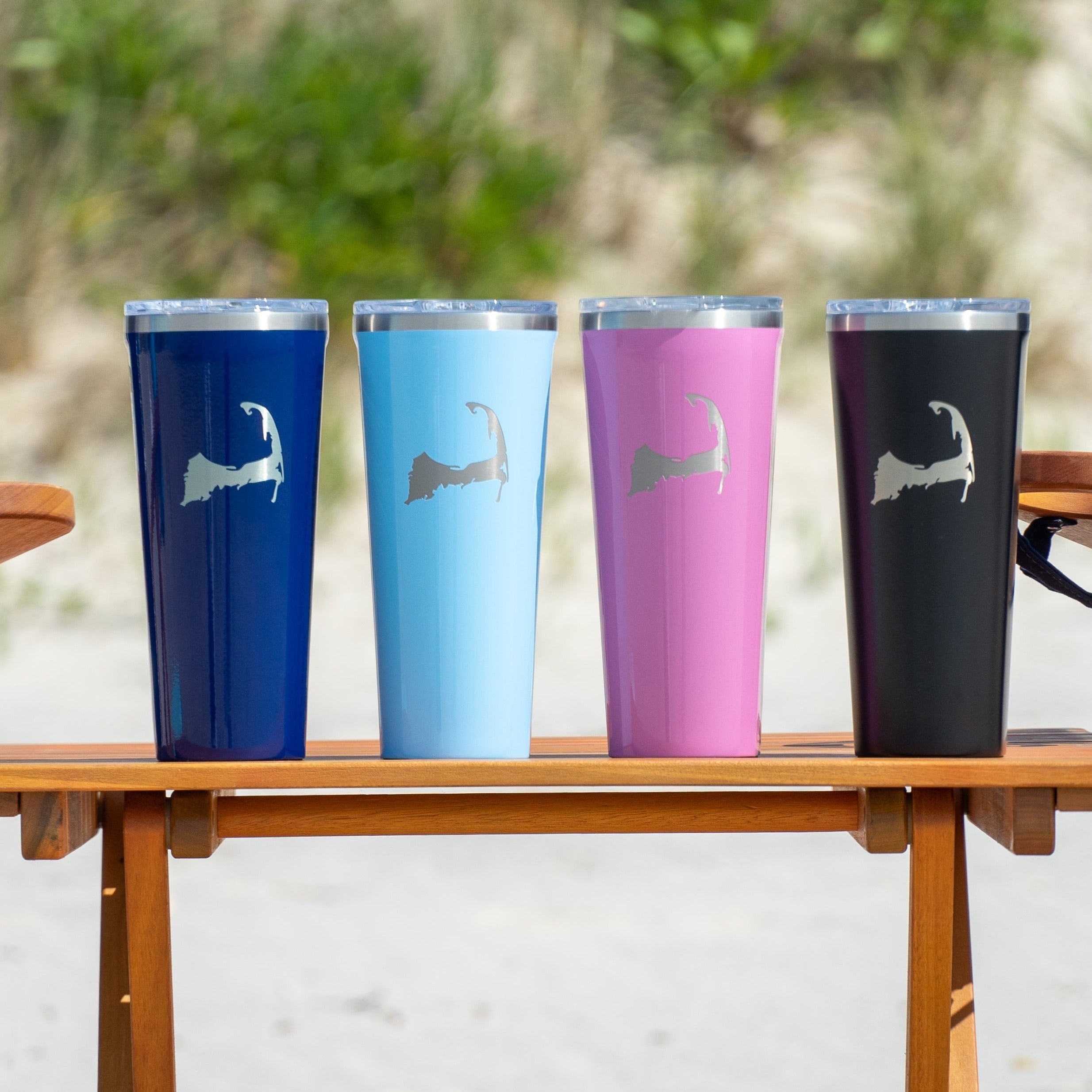 Colorful cape cod corkcicle tumblers on wood beach table