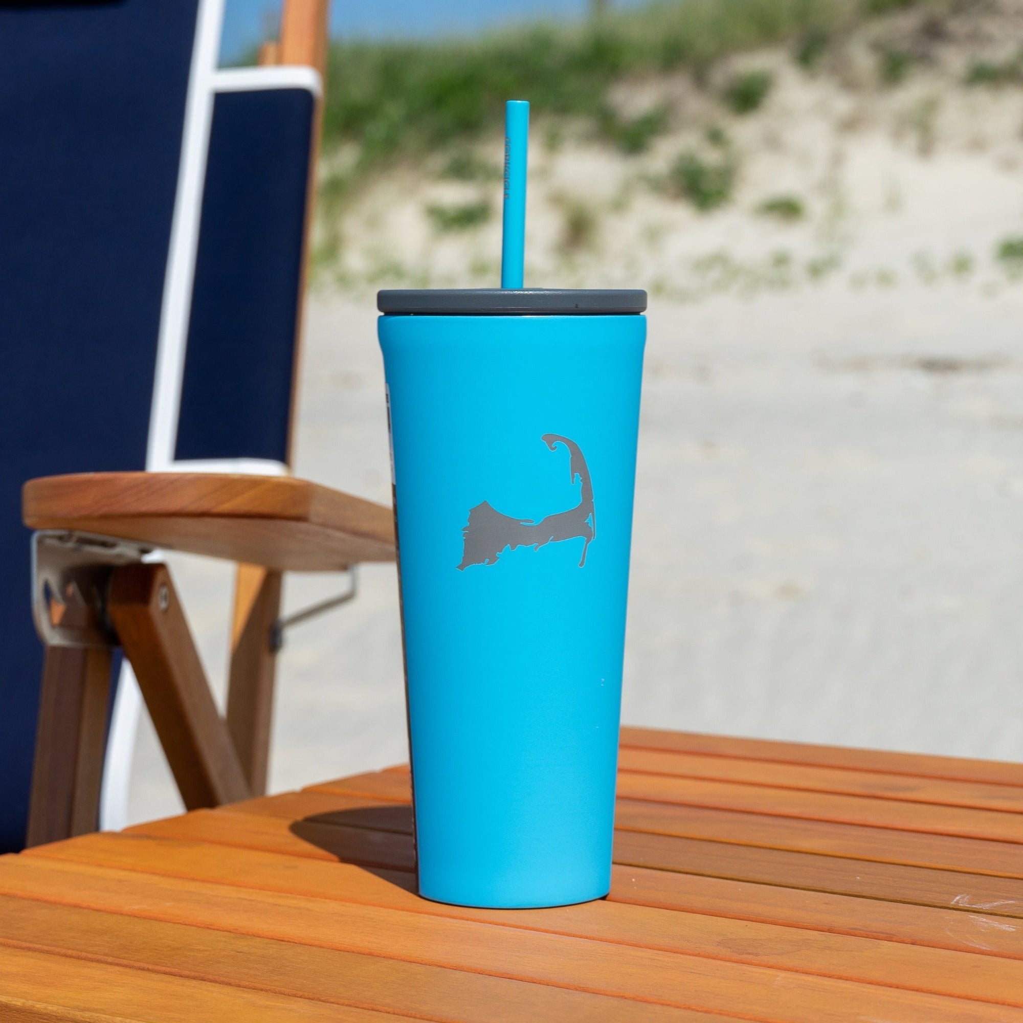 Blue cape cod tumbler on wood beach table