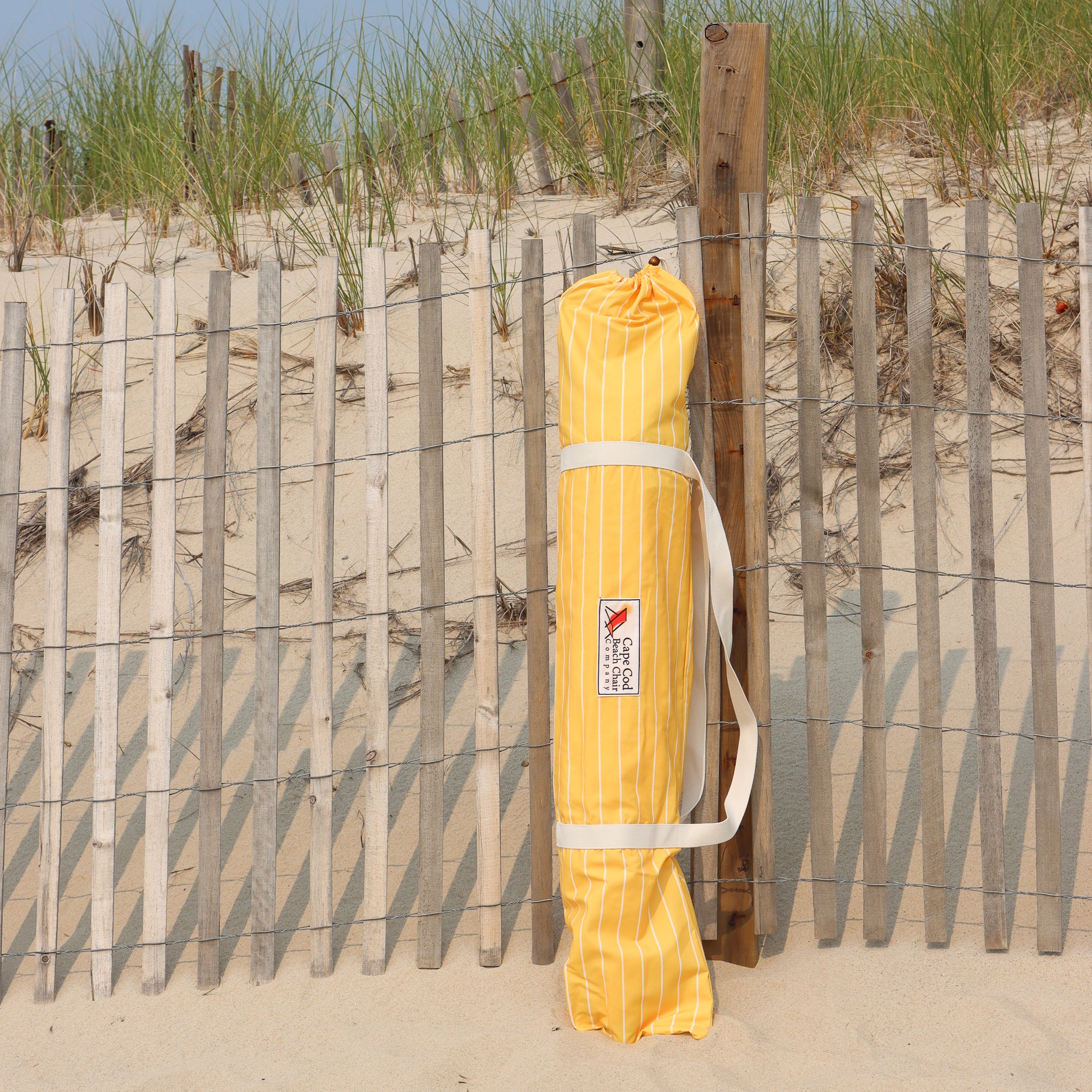 Yellow pinstripe carrying bag for beach umbrella
