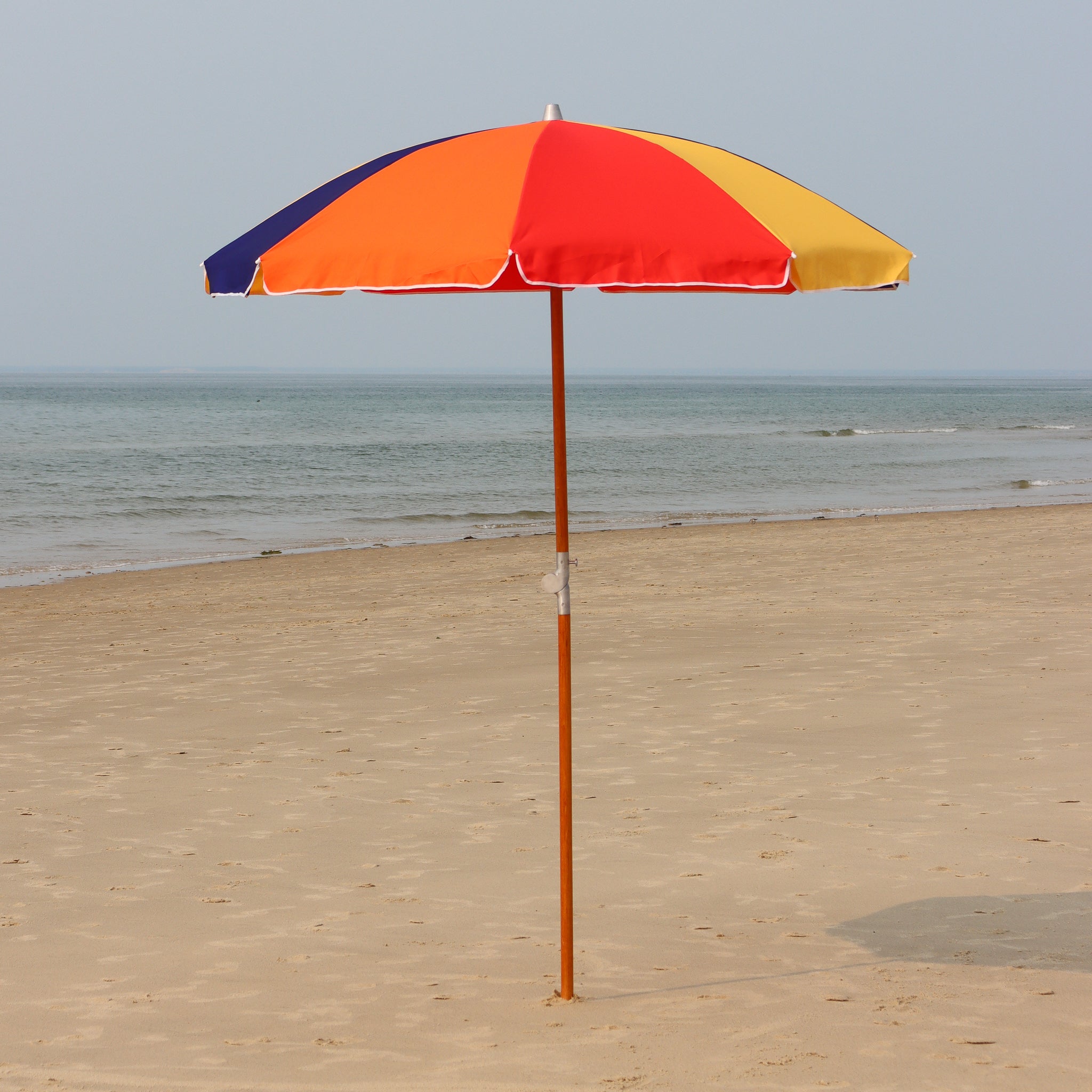 Rainbow panel beach umbrella on Cape Cod beach