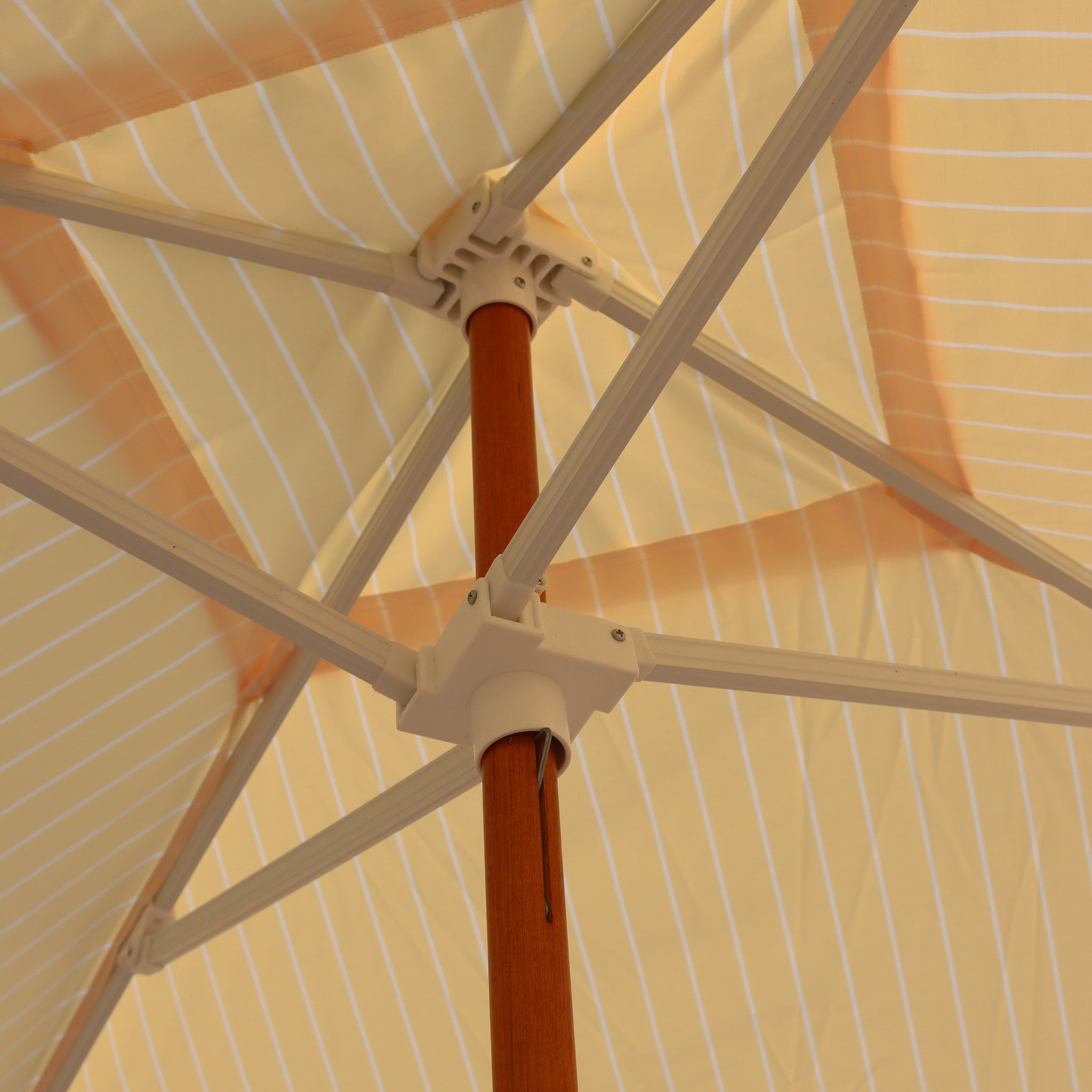 Sturdy frame for white beach cabana with rainbow stripes