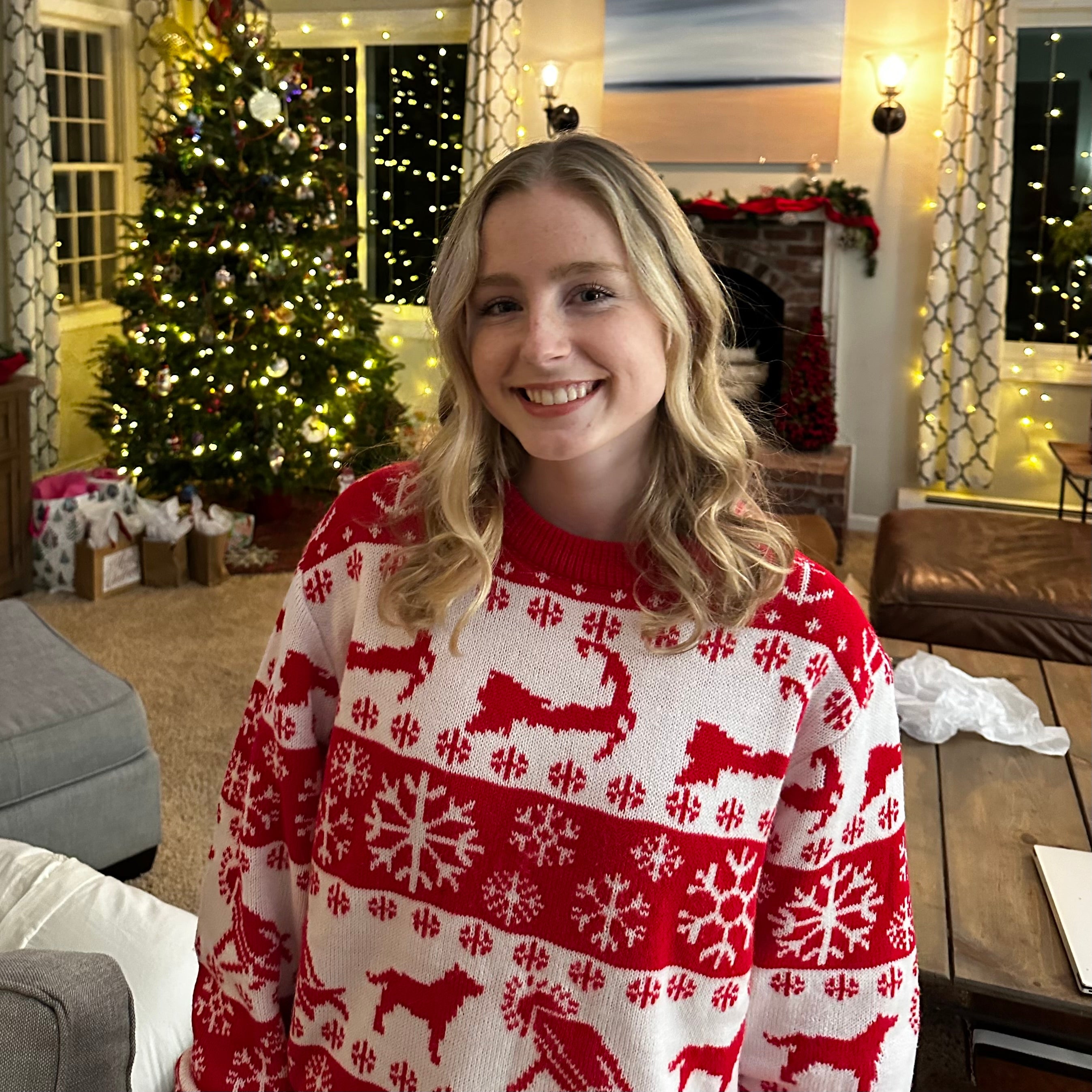 Happy Girl Wearing Red and White Cape Cod Christmas Sweater on Christmas Morning