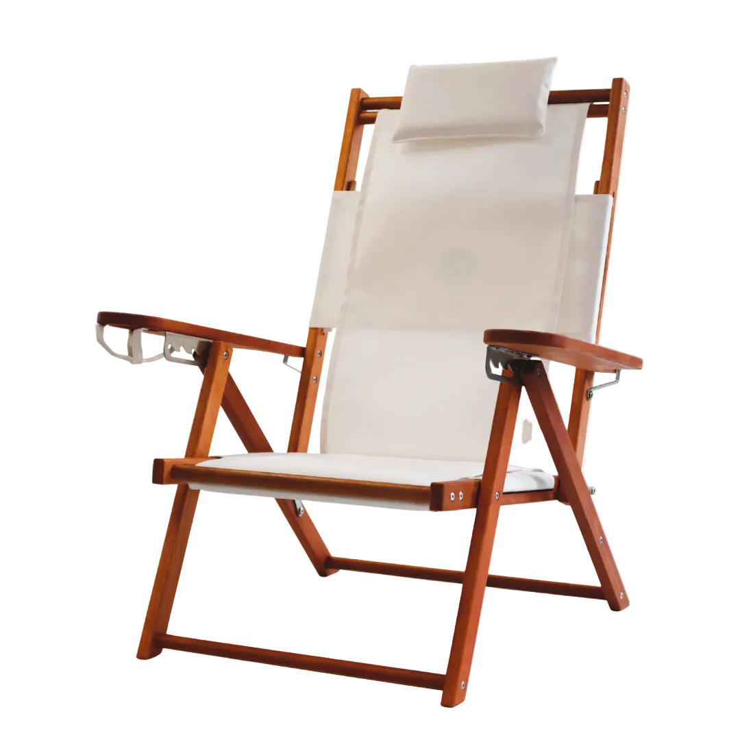 Wooden folding beach chair with white canvas seat and backrest on a white background