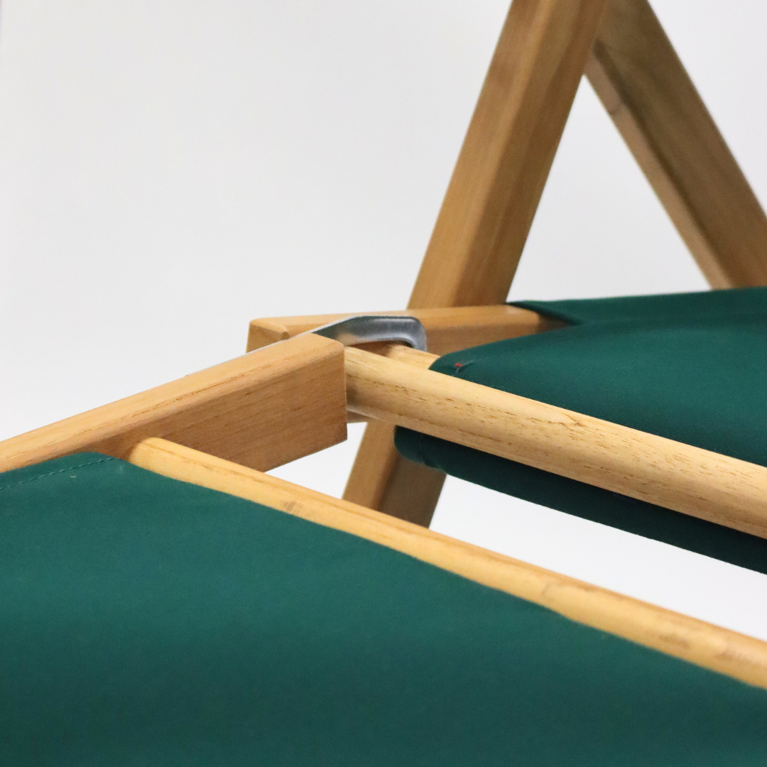 Close-up of a wooden chair with green fabric