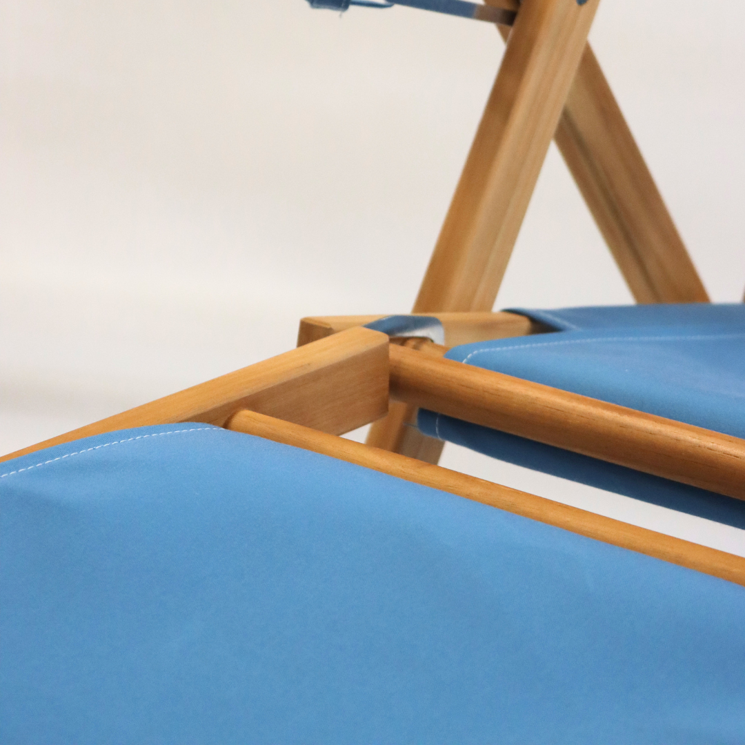 Close-up of a light blue beach chair with footrest attachment