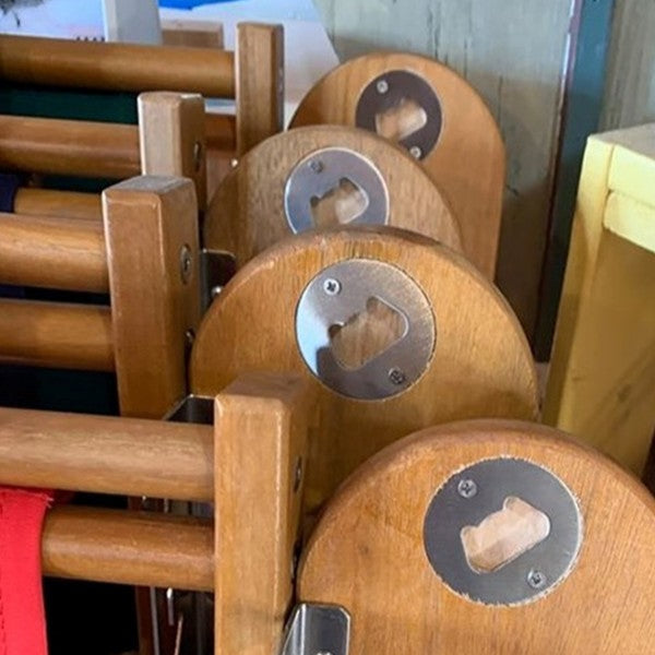 wooden beach chair with bottle opener built into armrest
