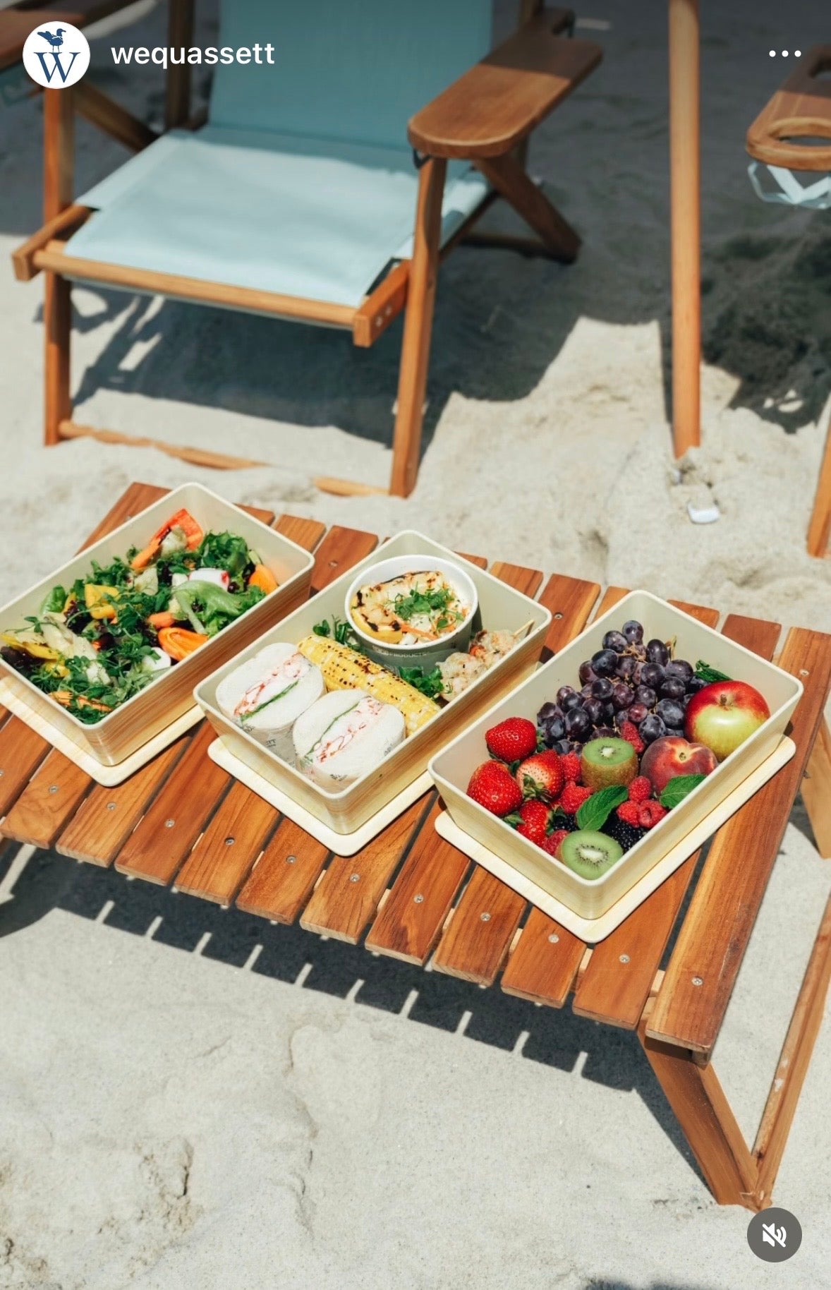 A folding teak table on the beachused for aesthetic picnic at Wequassett Resort on Cape Cod.
