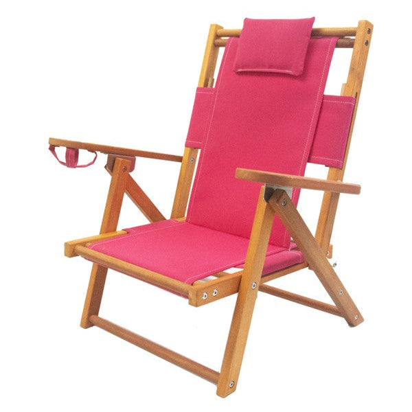 Pink wooden children's beach chair with pillow and cupholder