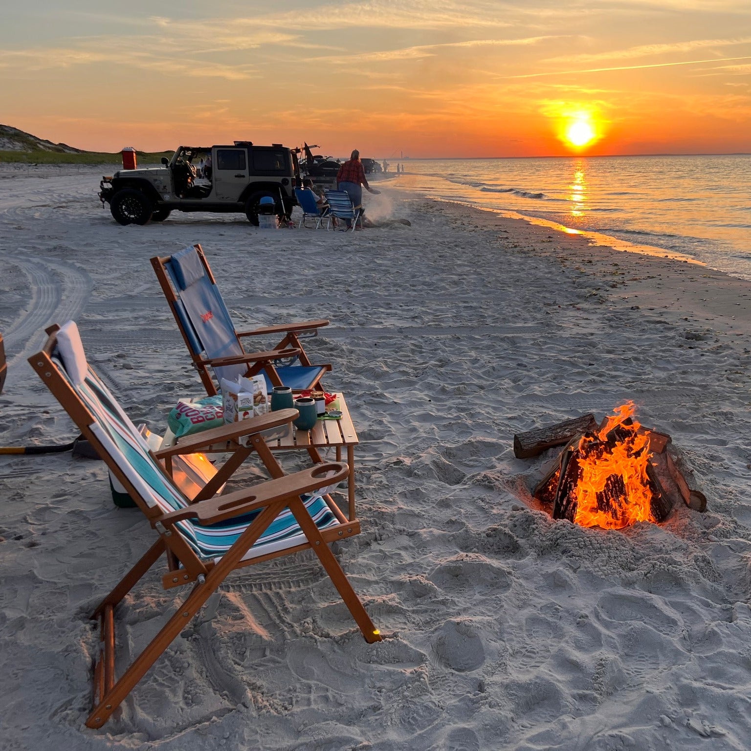 Wooden beach chairs with beach bonire at sunset