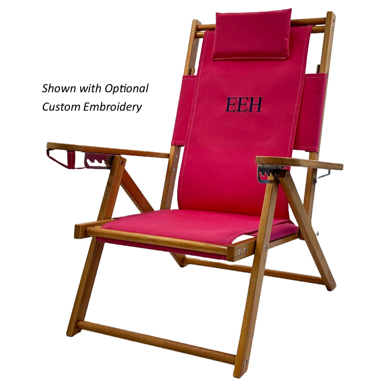 A pink wood and canvas beach chair personalized with embroidered initials.