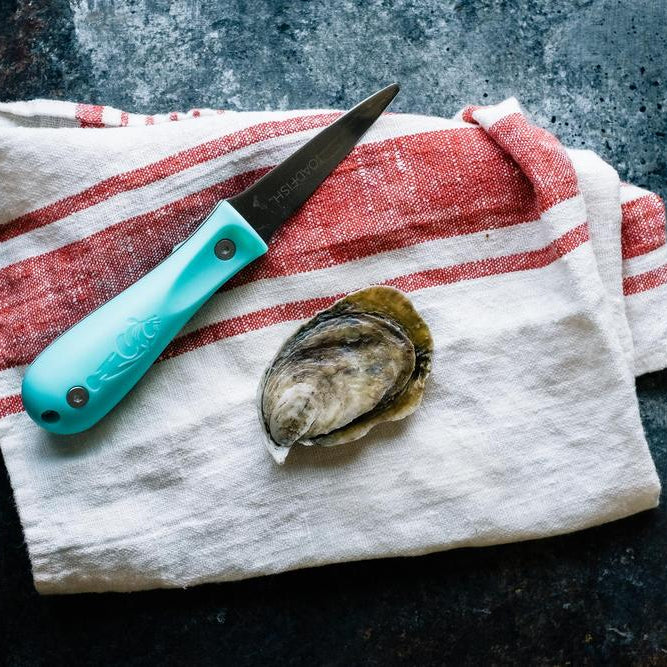 oyster knife with towel and oyster
