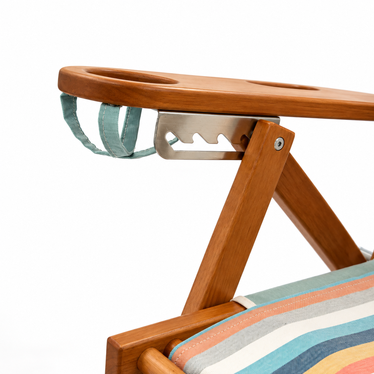 Close-up of a wooden folding beach chair showing the armrest attachment with drink holder, metal bracket, and part of a striped fabric seat on a white background.