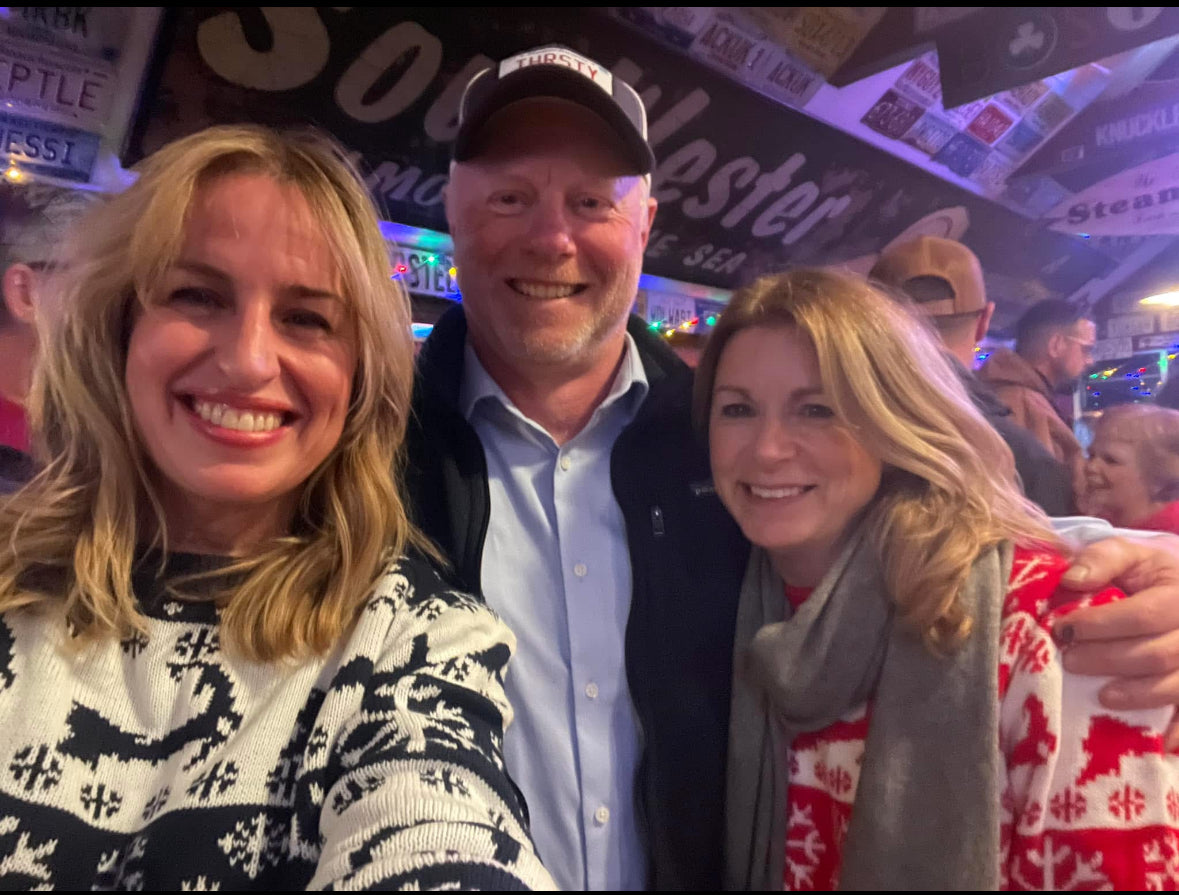 People wearing the Cape Cod Christmas Sweater while holiday strolling in Chatham.