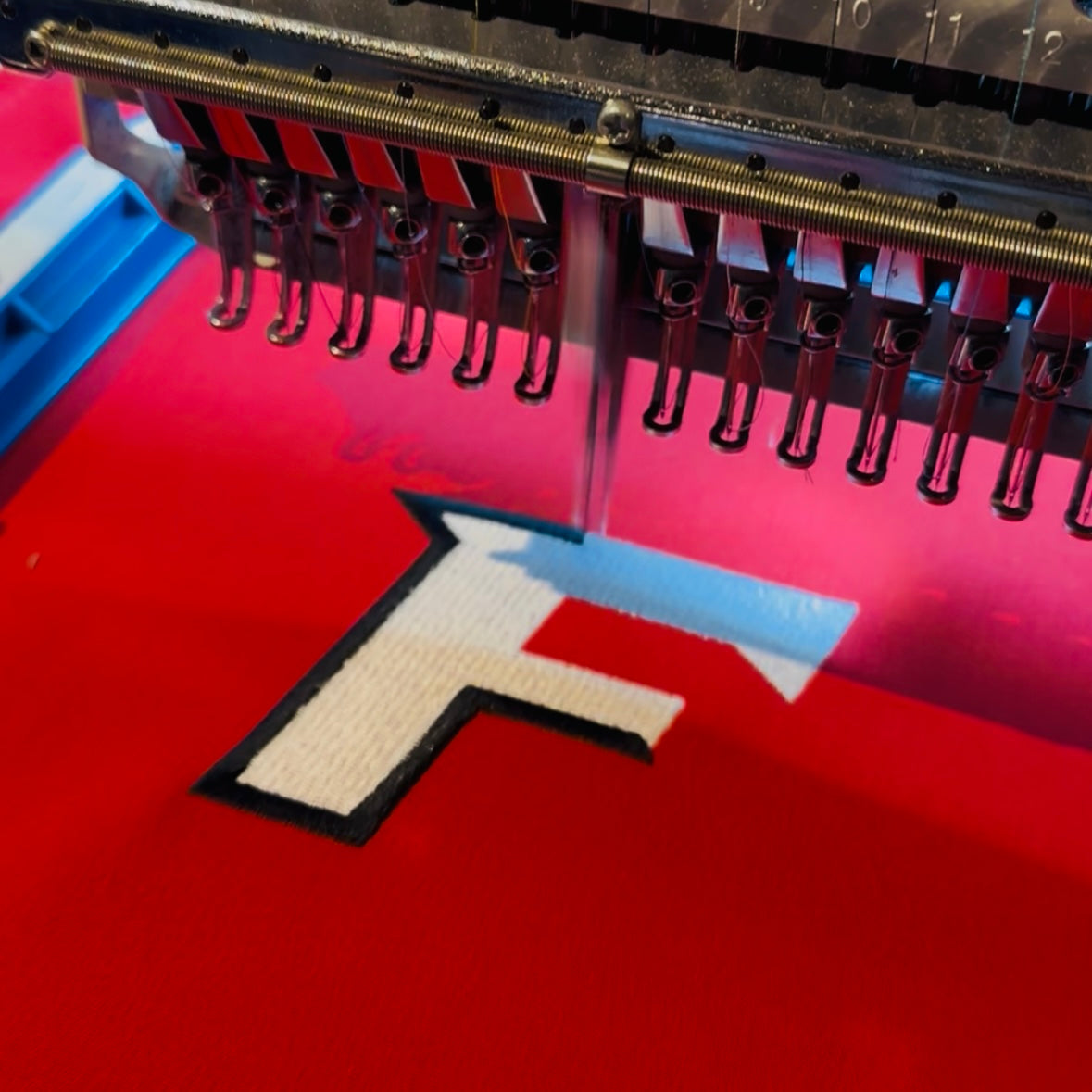 Embroidering the Fairfield University logo on a custom graduation gift chair.