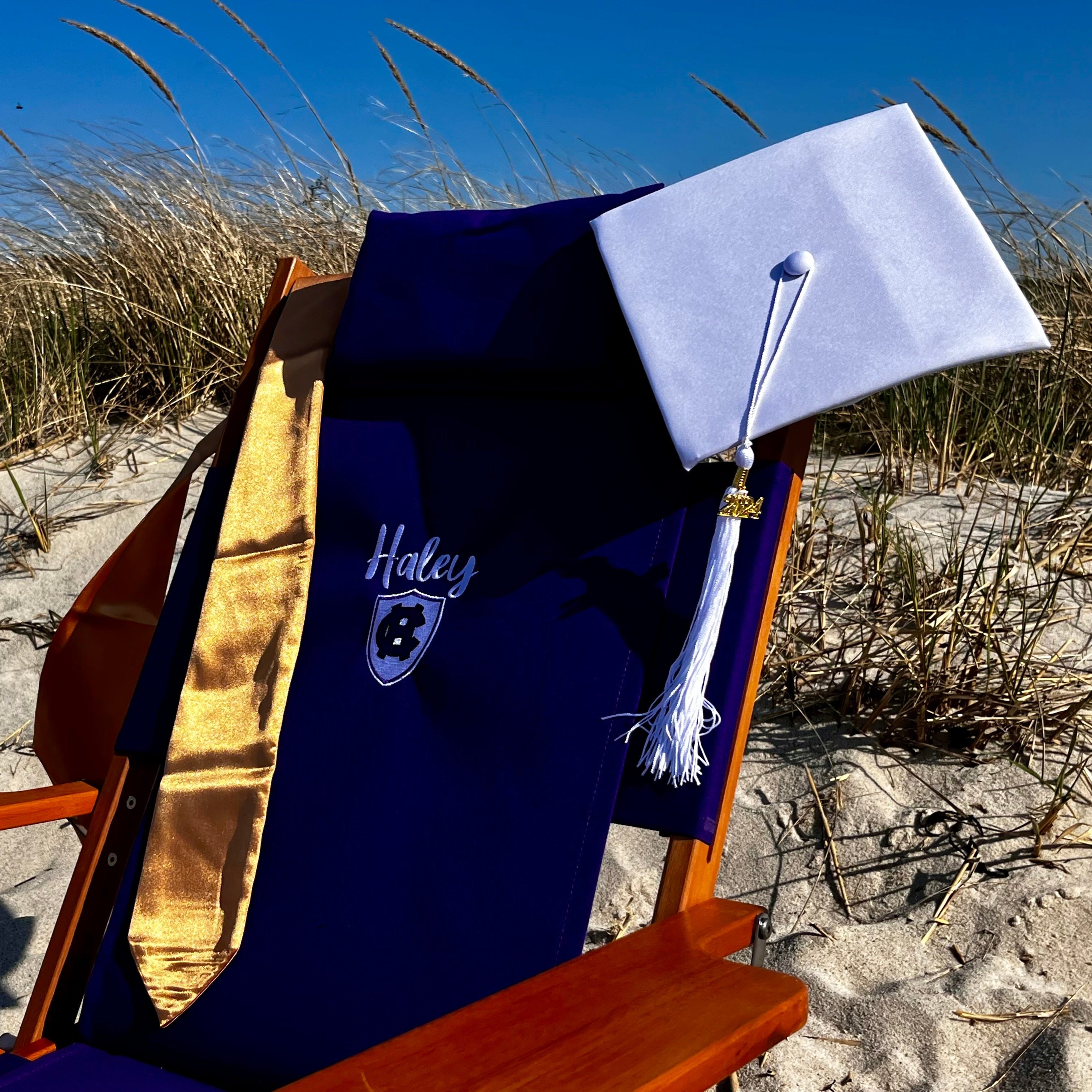 Custom Embroidered Wood Holy Cross College Beach Chair decorated with Graduation Cap
