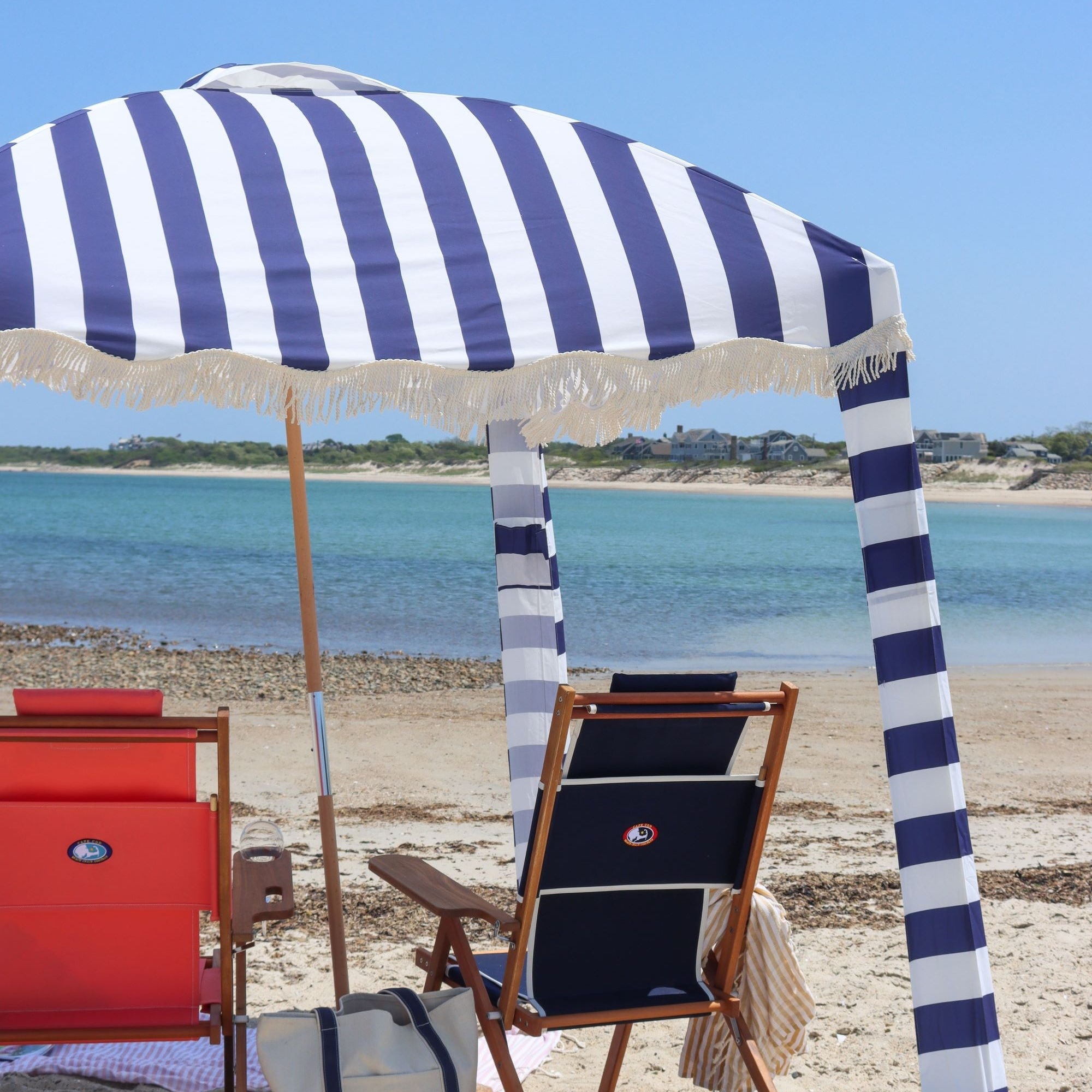 blue and white stripe beach cabana with beach chairs on Nantucket