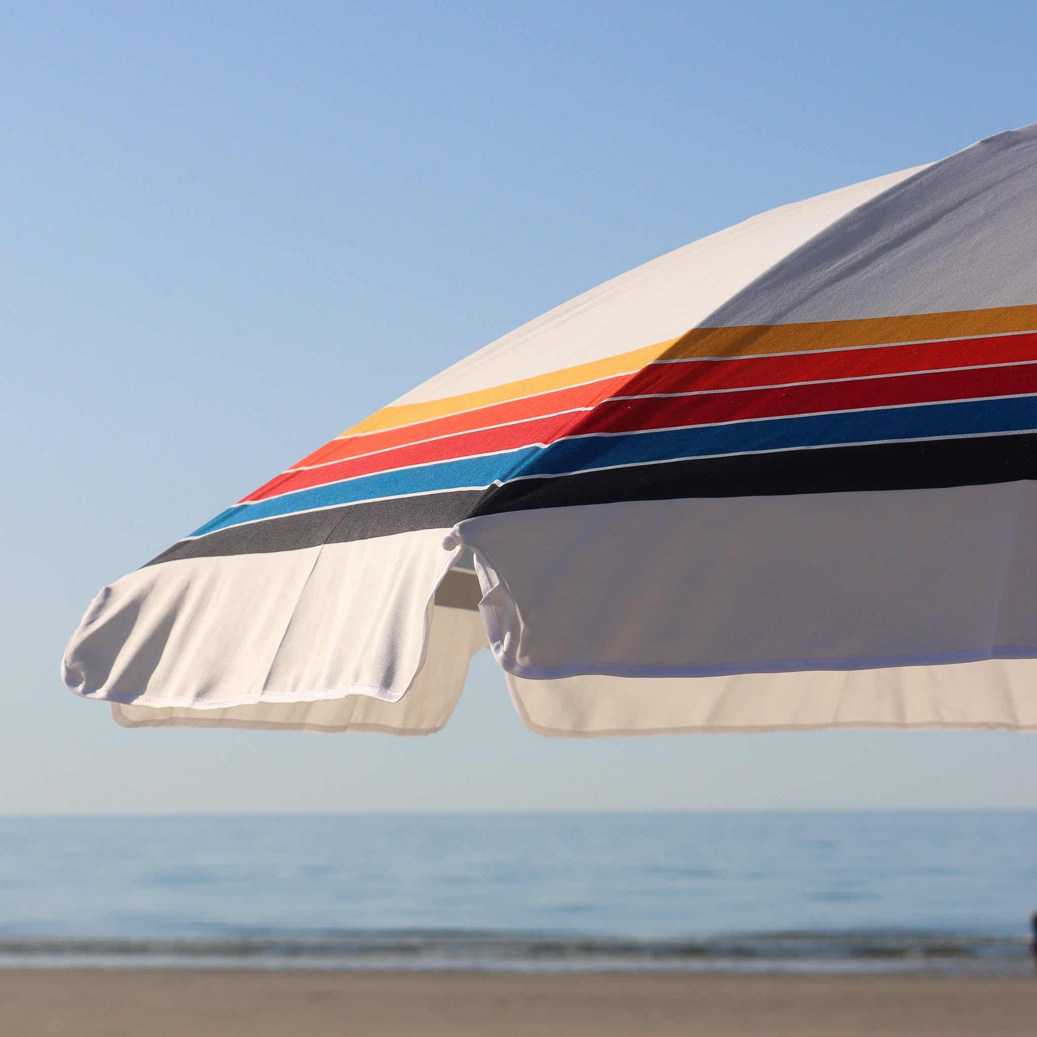 beach umbrella with rainbow stripes