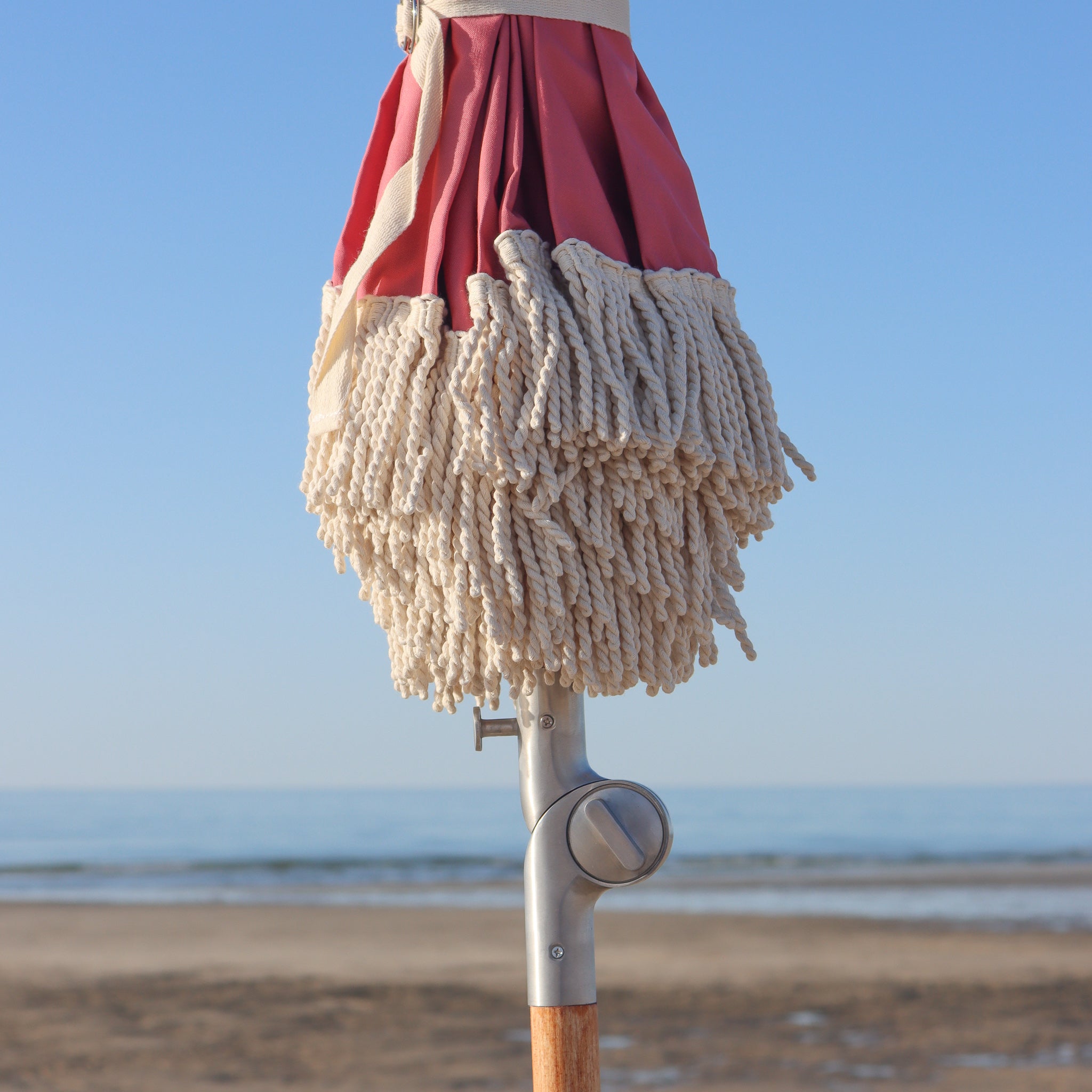 cotton tassels on nantucket red beach umbrella