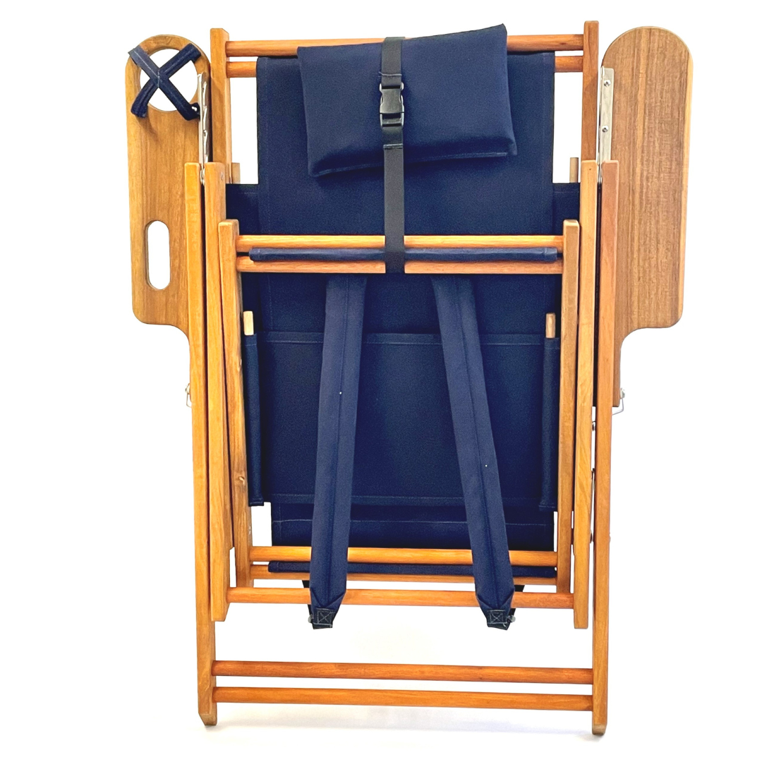 Blue backpack chair with straps on a wooden stand against a white background