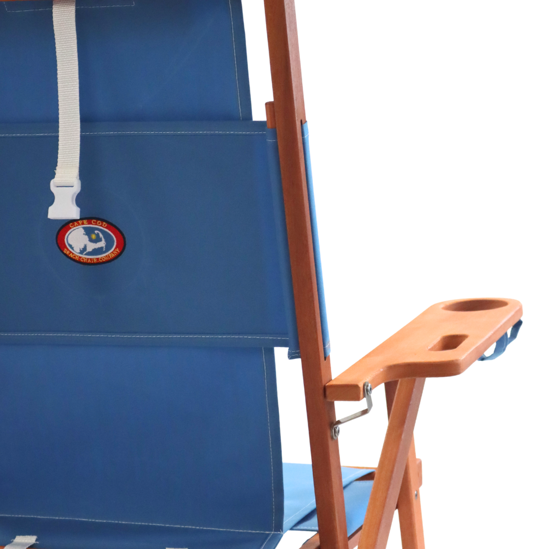 Blue folding backpack chair with a wooden armrest on a white background
