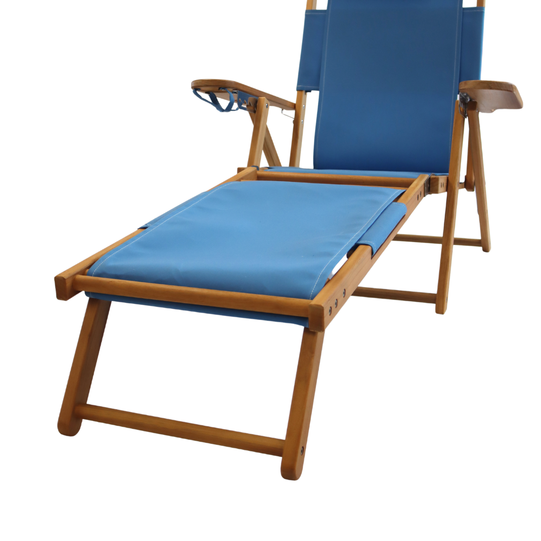 Blue beach chair with wooden frame and footrest attachment