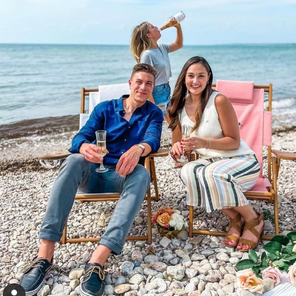 A happy couple sitting on the beach after their wedding