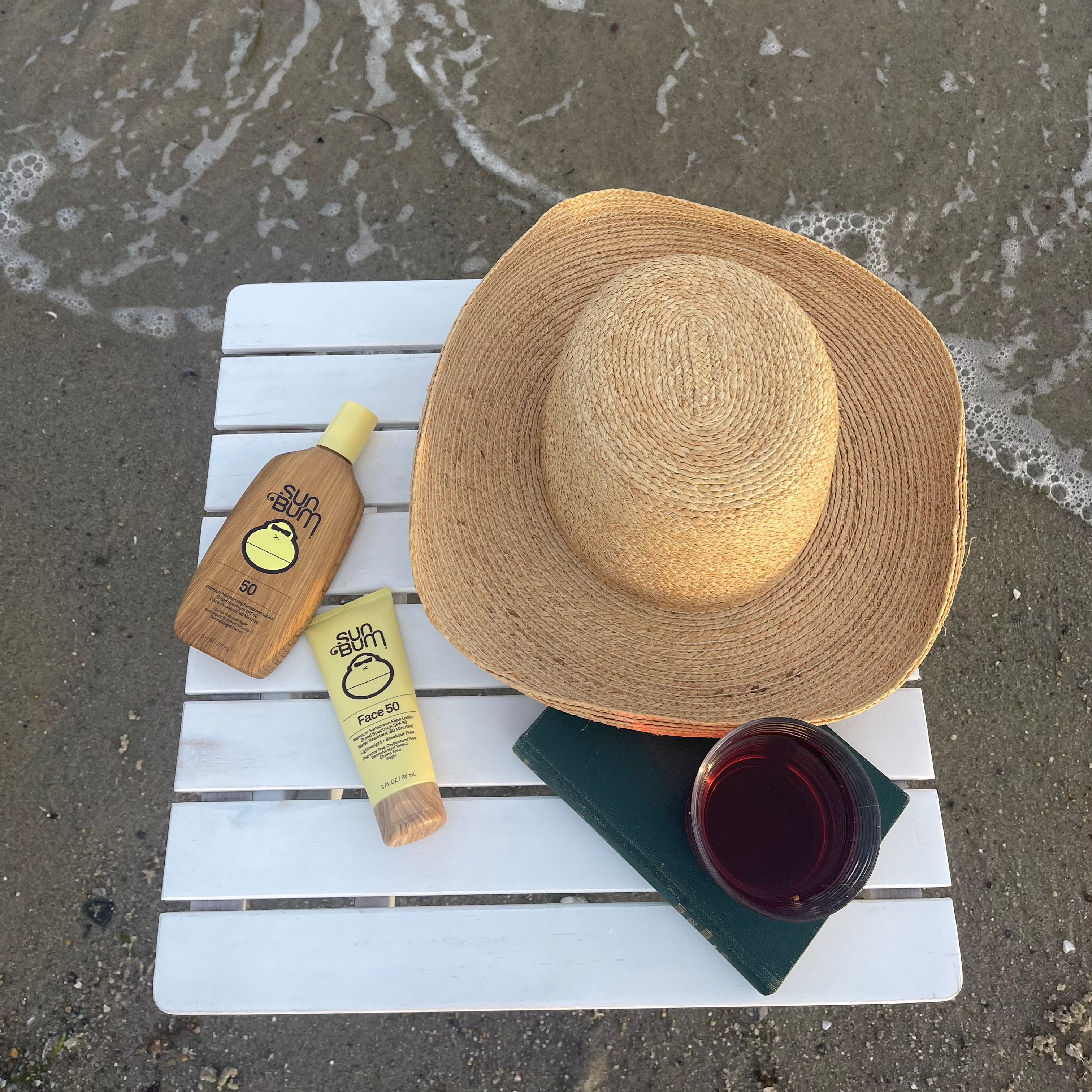 white folding beach table by the ocean